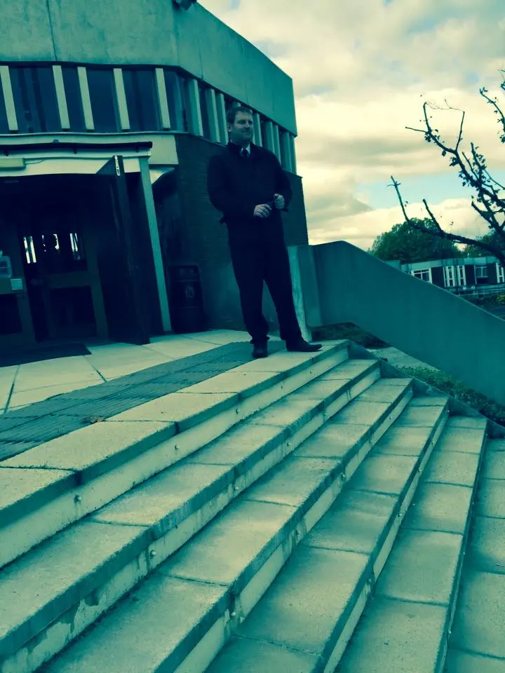 Security officer standing on the steps outside a building