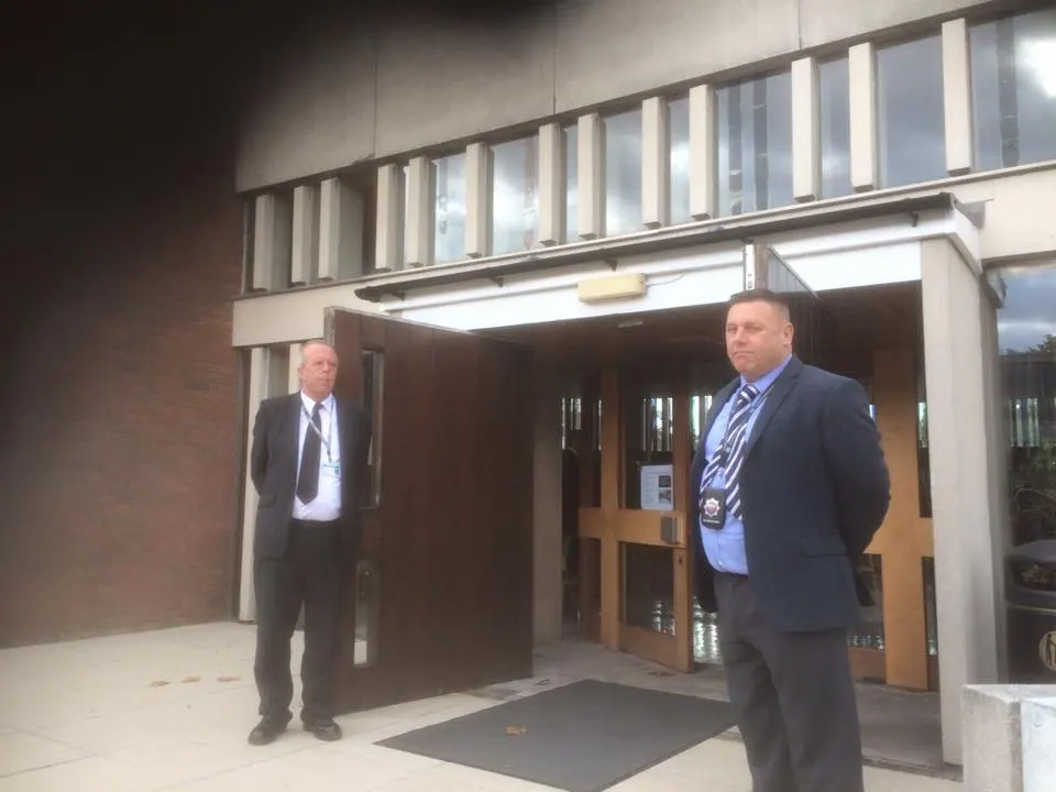 Two Cofton Security officers standing at a building entrance